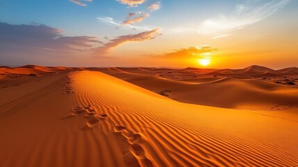 Sunset over the Sahara Desert: Golden Dunes and Footprints