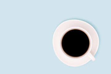 Cup with black coffee on a blue background. Composition with copy space.