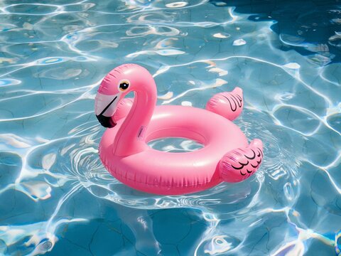 Pink Inflatable Flamingo Float on Clear Blue Swimming Pool Water