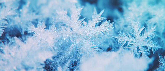 Winter wonderland with delicate snowflakes in cool blue hues against a dark backdrop