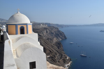 The dramatic steep views over the edge of the volcano crater of Santorini Island overlooking the...
