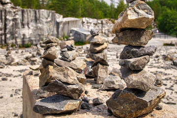 Stacked stones in a tranquil quarry on a sunny day surrounded by lush greenery