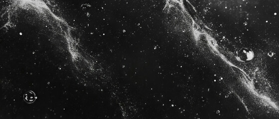 Bubbles burst and create dynamic splashes against a dark background