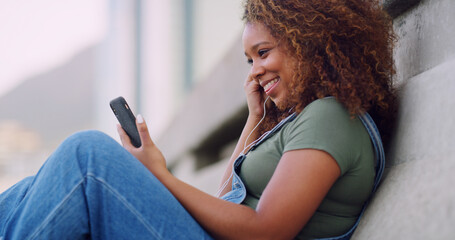 Happy woman, relax and earphones with phone in city for video call, music or communication. Female person, tourist or user with smile on mobile smartphone for online connectivity or network in town
