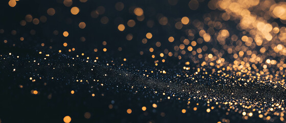 Confetti texture with depth of field showcasing three-dimensional gold effects on black backdrop