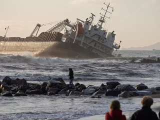 Selbstklebende Fototapeten The ship stranded and wrecked. Stormy sea in overcast weather waves crash on a pier near the shore in marina di massa tuscany italy © manola72