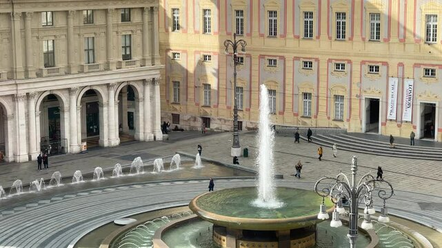 Piazza Ferrari with fountain in Genoa. Buildings and architecture of old town. View from above on sunny winter day in 2025.