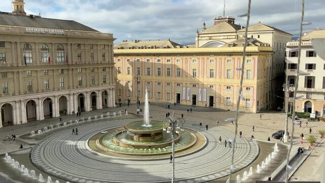 Piazza Ferrari with fountain in Genoa. Buildings and architecture of old town. View from above on sunny winter day in 2025.