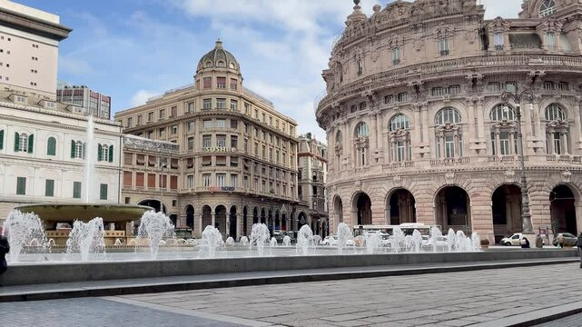 Piazza Ferrari with fountain in Genoa. Buildings and architecture of old town. View from above on sunny winter day in 2025.