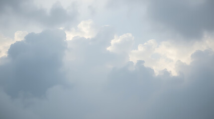 Obraz premium Cloudy sky, soft gray clouds, diffused sunlight, ethereal atmosphere, muted tones, heavenly backdrop, serene cloudscape, overcast day, gentle light, dreamy skyscape, wispy cloud formations, atmospheri