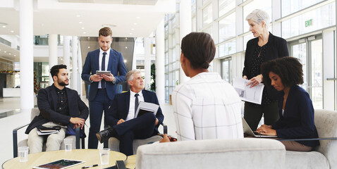 Collaboration, corporate and meeting with business people in lobby of office for planning or strategy, Coaching, management and training with employee team in discussion of company development