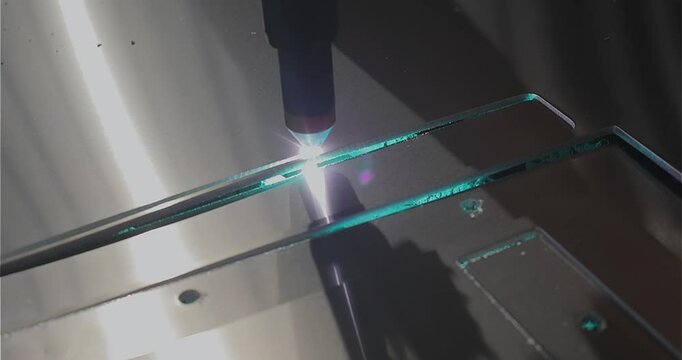 The plasma cutter will cut the part. Plasma cutting. Plasma cutter work at the factory. The process of cutting a metal part with a plasma cutter