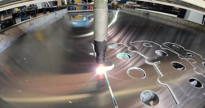 Plasma cutting. Plasma cutter work at the factory. The plasma cutter will cut the part. The process of cutting a metal part with a plasma cutter