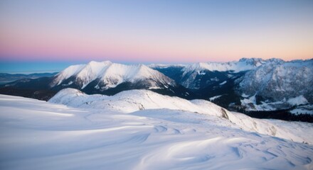 Fototapeta premium Serene winter landscape with snow-covered mountains at sunset