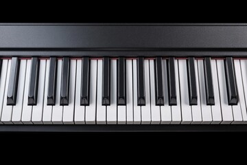 Fototapeta premium A close-up view of a piano keyboard showing the black and white keys