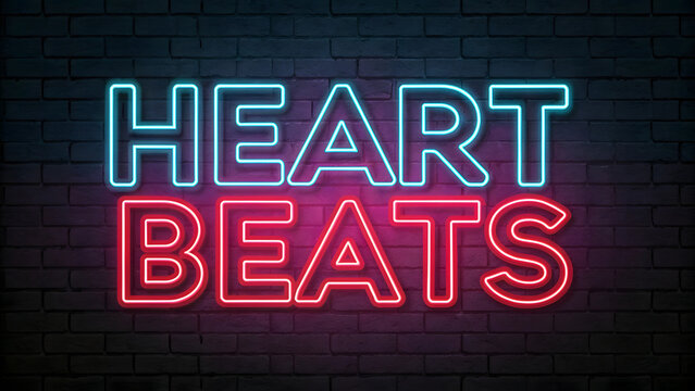 This image showcases the phrase "HEART BEATS" rendered in a bold, illuminated neon sign against a dark brick wall background.