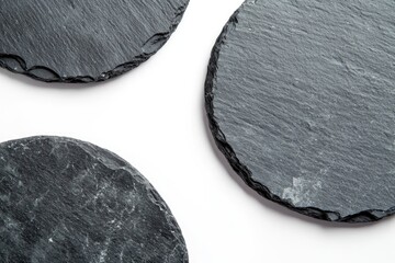 Close-up photo of three slate coasters arranged on a table