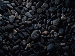 Textured dark stones create an abstract natural background for creative design and art