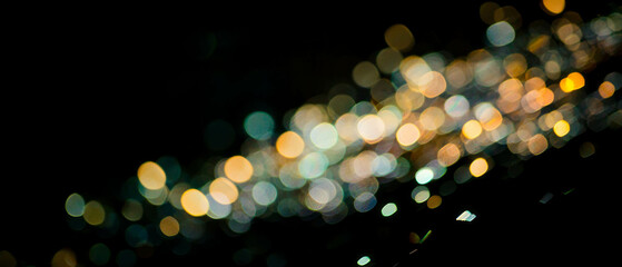 Modern light bokeh texture with triangular shapes and sharp angles on black background
