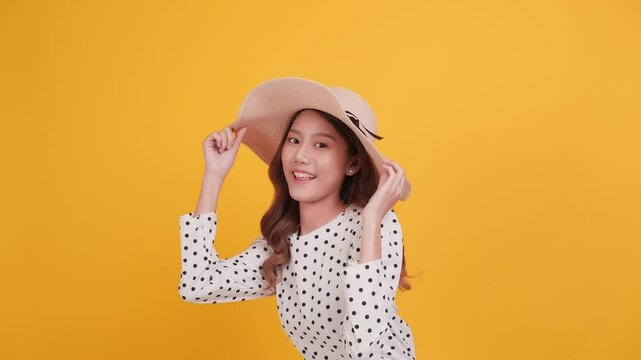 Cheerful Asia Woman with hat giving miniheart