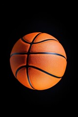 A solo basketball on a dark background, ideal for sports-related designs or branding
