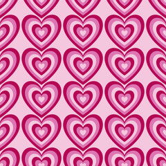 Seamless pattern wint hearts in pink colours on a light pink background. Vector Valentine's Day background.