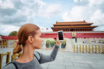 Enjoying vacation in China. Travel and technology. Young woman taking photo by smartphone in...