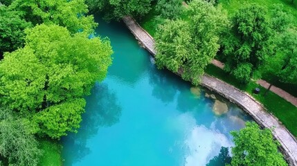 Aerial view of a serene river surrounded by lush green trees park nature photography tranquil environment