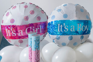Colorful balloons decorate a gender reveal party