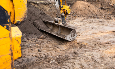 excavator on a construction site. Excavator digging earth for earthworks and construction. Heavy equipment for earthworks and construction