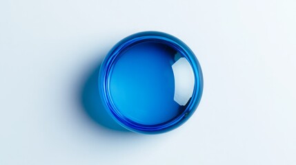Glossy blue plastic cap against a clean white background, top-down view.