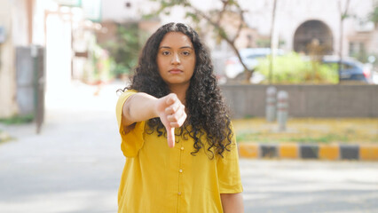 Indian Woman with Curly Hair Showing Thumbs Down