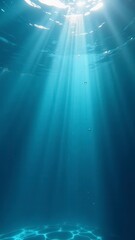 Underwater sunlight creates stunning beams of light in deep blue ocean