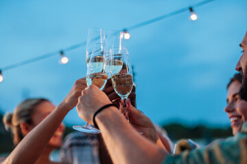 Friends toasting with sparkling wine at a rooftop party
