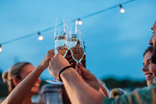 Friends toasting with sparkling wine at a rooftop party