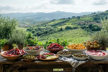 Italian buffet overlooking rolling hills of tuscany with salami, olives, and apricots