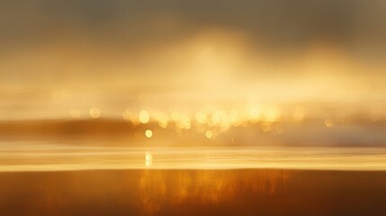 Fototapeta premium A blurry image of a beach with a golden sunset in the background