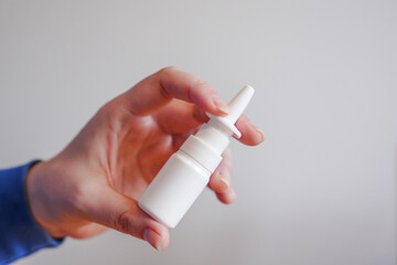 nose sprays, sprays for the nose, nasal spray in hand on a white background