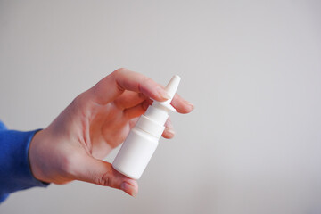 nose sprays, sprays for the nose, nasal spray in hand on a white background