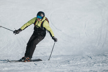 A man skillfully skiing down a snowy slope, showcasing winter sports techniques and enthusiasm...