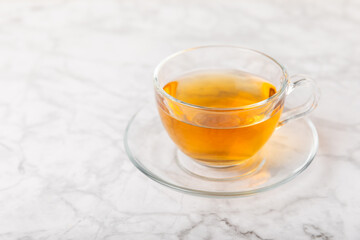 Cup of hot ginger tea with slices of ginger root on wooden background. Warming drink. Alternative medicine. Tea with honey, lemon, ginger and mint. Space for text. Copy space