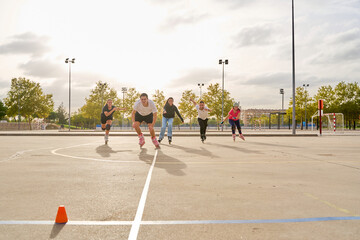 Group of rollerbladers racing outdoors on a sunny day
