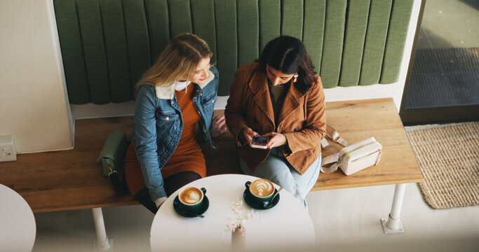 Women, friends and above with phone at cafe with scroll, video and share post on social media. Girl, people and relax with smartphone, cappuccino and reunion with chat on mobile app at coffee shop