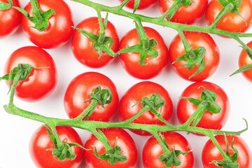Branches of fresh cherry tomatoes isolated on white