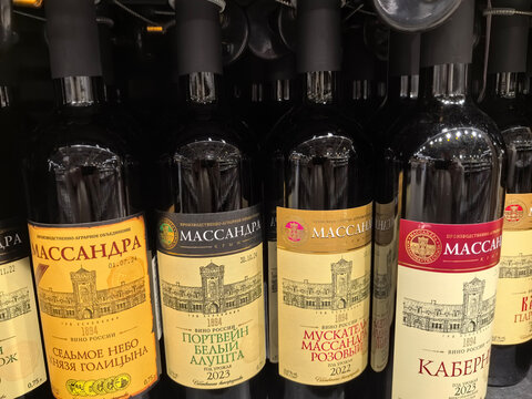 Bottles of exquisite wine displayed in a store on a sunny afternoon