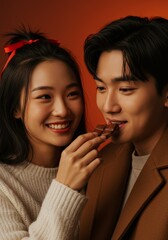 Naklejka premium Cheerful young couple enjoy sharing a delicious chocolate bar in a studio setting