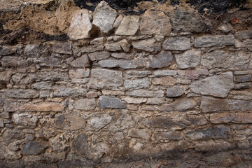 old stone wall made of granite stone