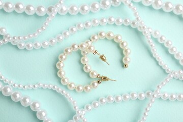 Stylish accessories on light blue background, flat lay