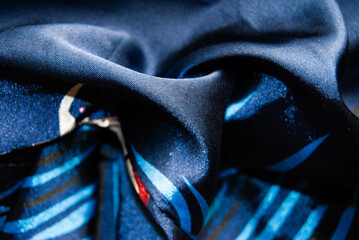 Smooth and luxurious blue silk fabric with intricate patterns.