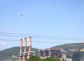 Obraz premium Cement plant pipes in a green mountain valley, Turkey, May 2023, 2